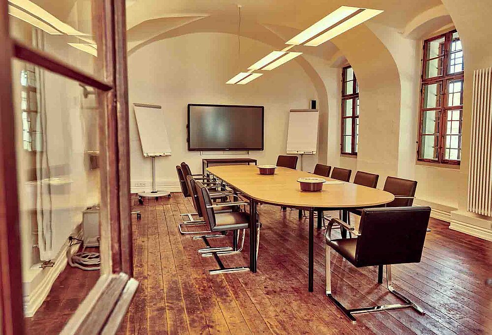 Konferenzraum mit Flipchart und Bildschirm